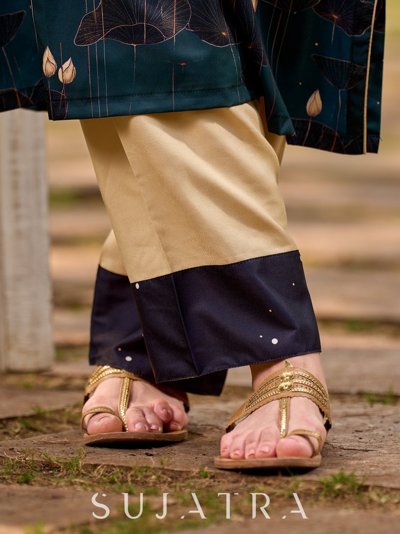 Elegant cream rayon pants with refined bottle-green print details.