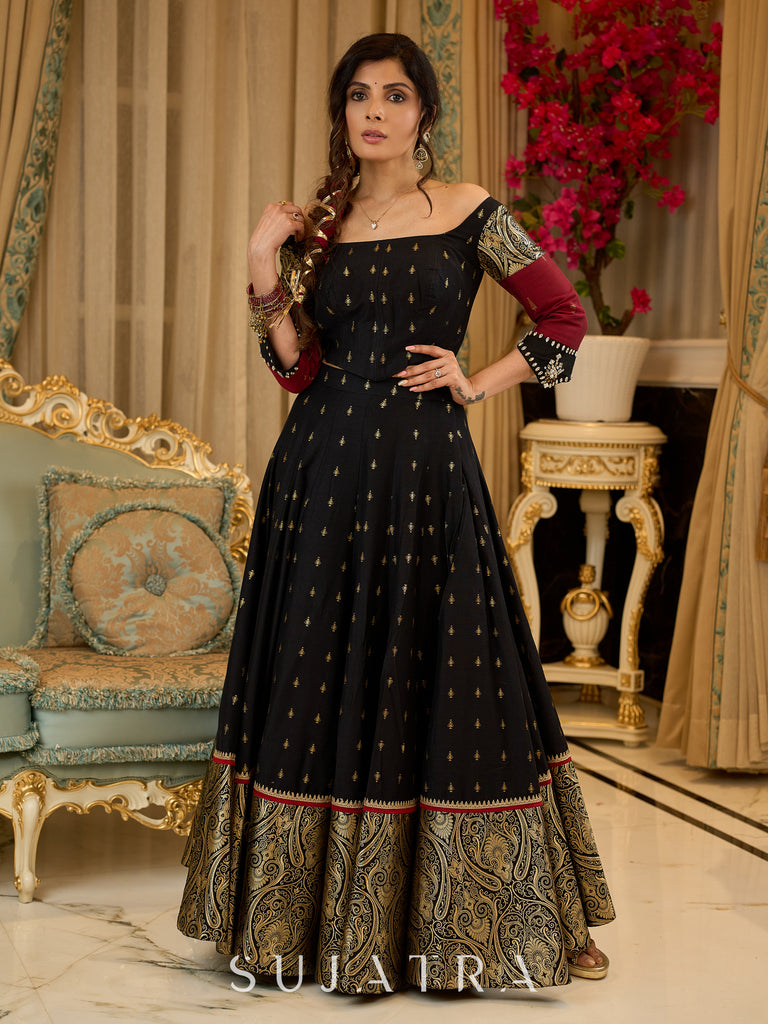 Black cotton silk & brocade lehenga paired with a sculpted corset style choli featuring intricate stonework on sleeves .