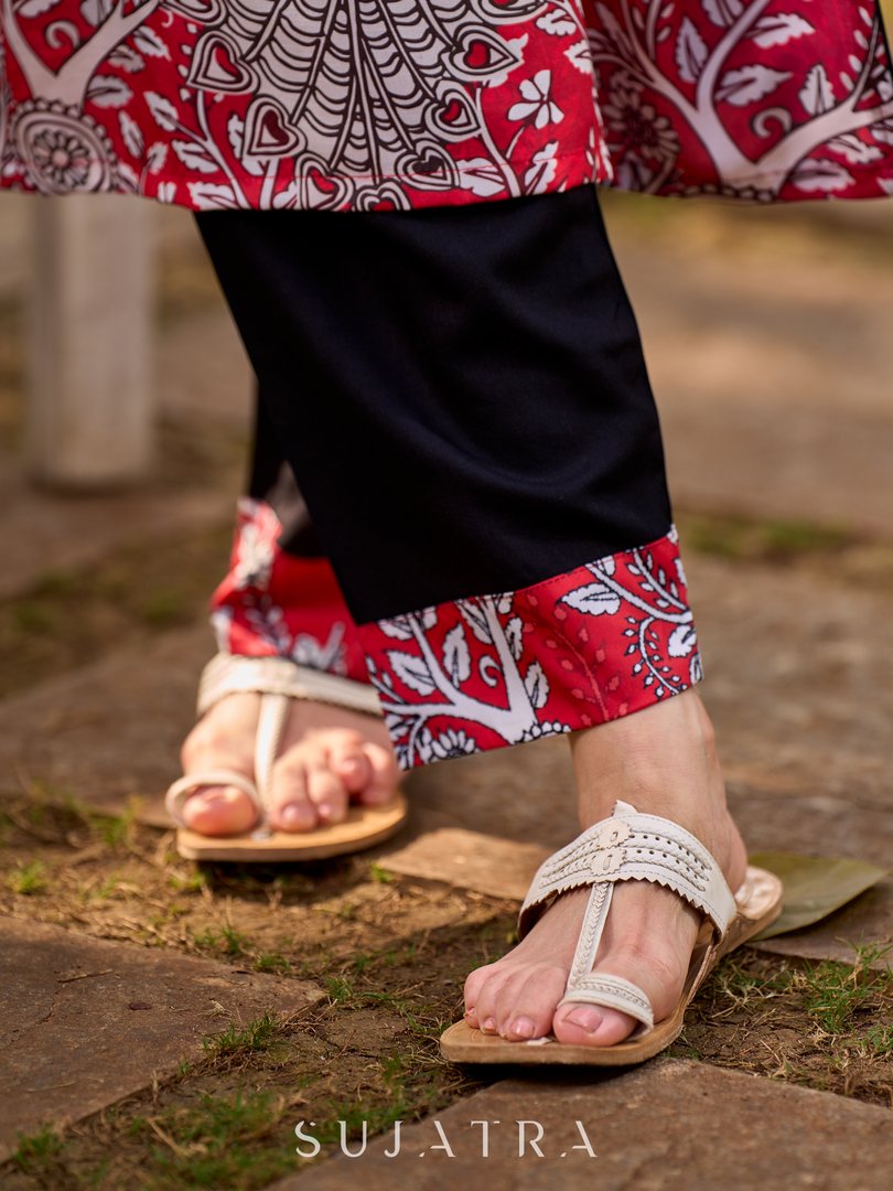 Timeless black rayon pants elevated with an artisanal red Kalamkari border.