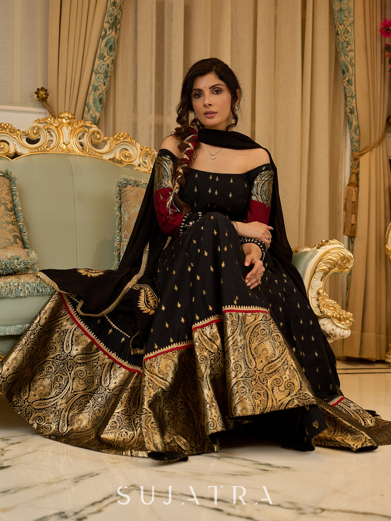 Black cotton silk & brocade lehenga paired with a sculpted corset style choli featuring intricate stonework on sleeves .