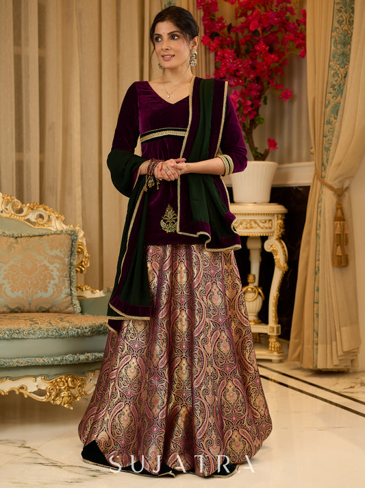 Royal Wine Lehenga with a scalloped hem and a luxurious velvet choli with Zardosi work .