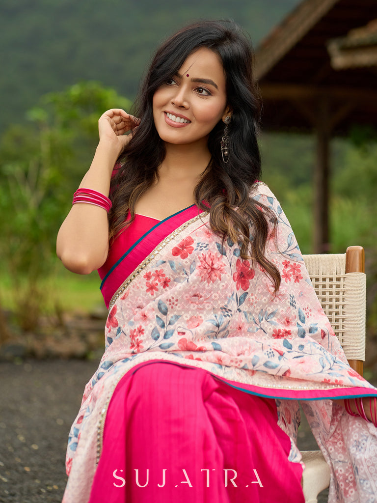 Floral-inspired white saree elevated with fuchsia pleats and borders