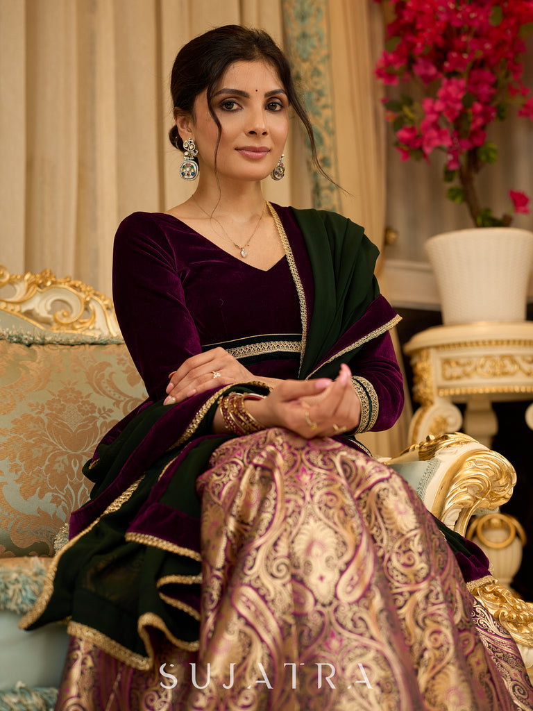 Royal Wine Lehenga with a scalloped hem and a luxurious velvet choli with Zardosi work .