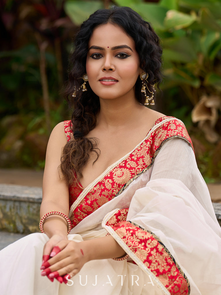 Ivory elegance with royal red Banarasi border, timeless festive glamour