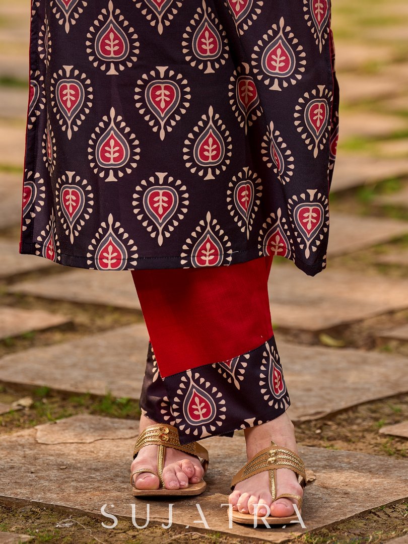 Chic red cotton pants accented with a striking black butti border