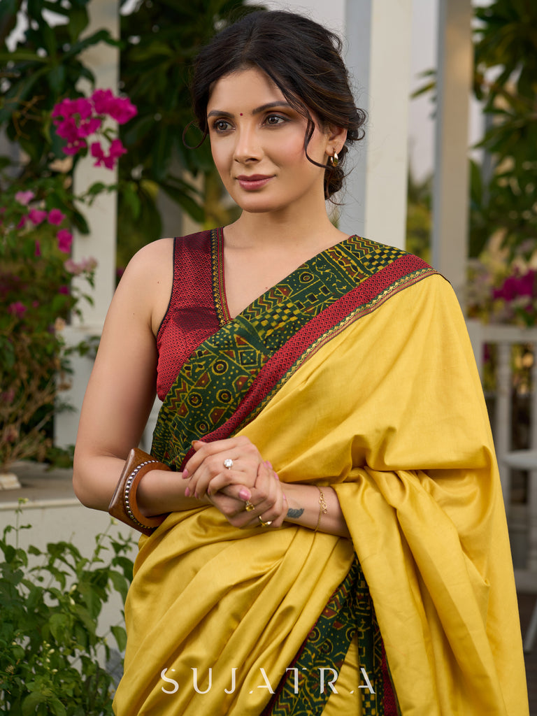 Vibrant yellow silk mix saree with hand block printed Ajrakh border