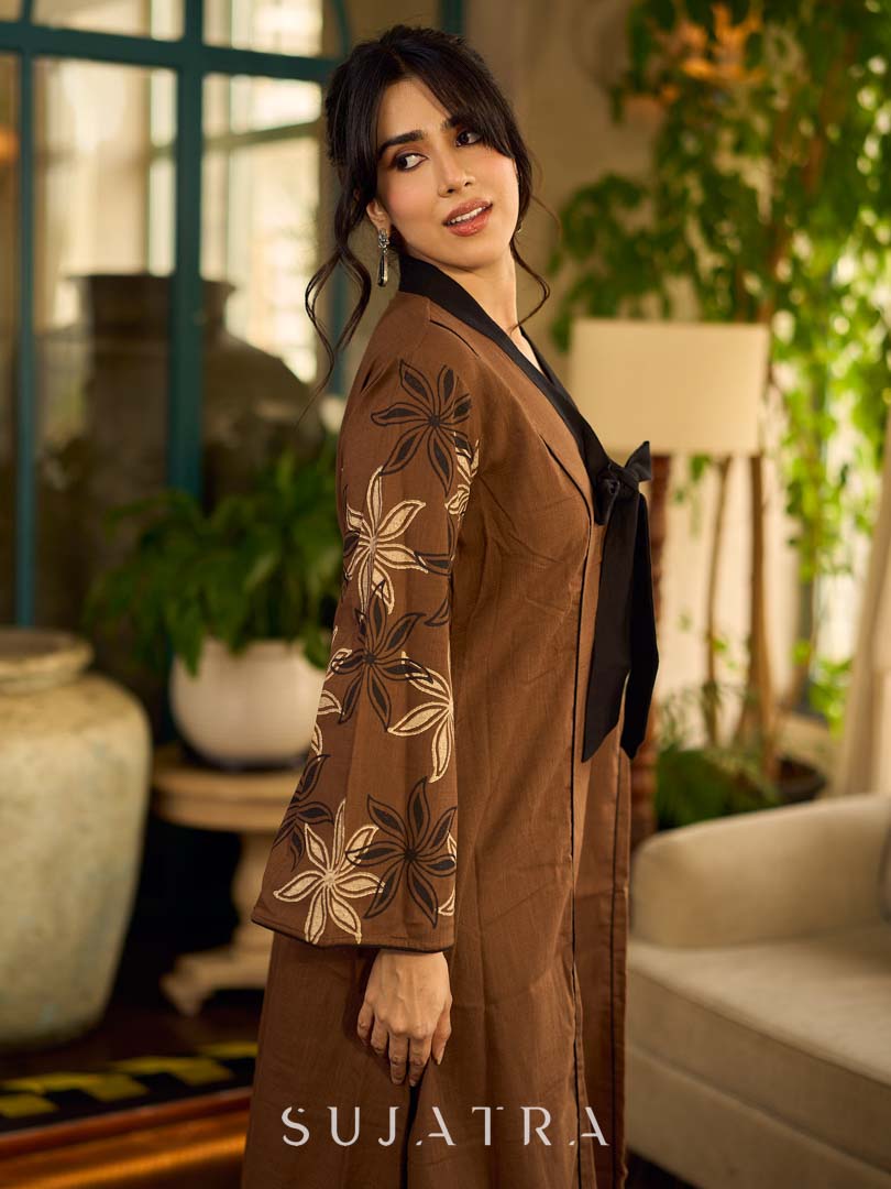 Brown block print dress with floral block printed flared sleeves, black tie-up neckline, and contrast black accents for an effortless, elegant everyday look.