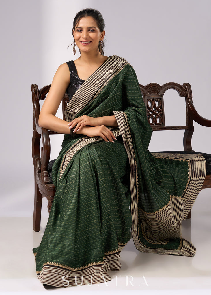 Elegant green cotton saree with intricate striped border & zari highlights