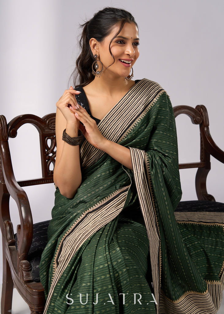 Elegant green cotton saree with intricate striped border & zari highlights