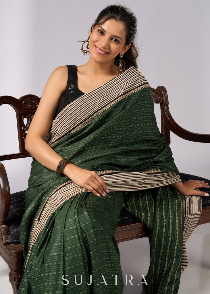 Elegant green cotton saree with intricate striped border & zari highlights