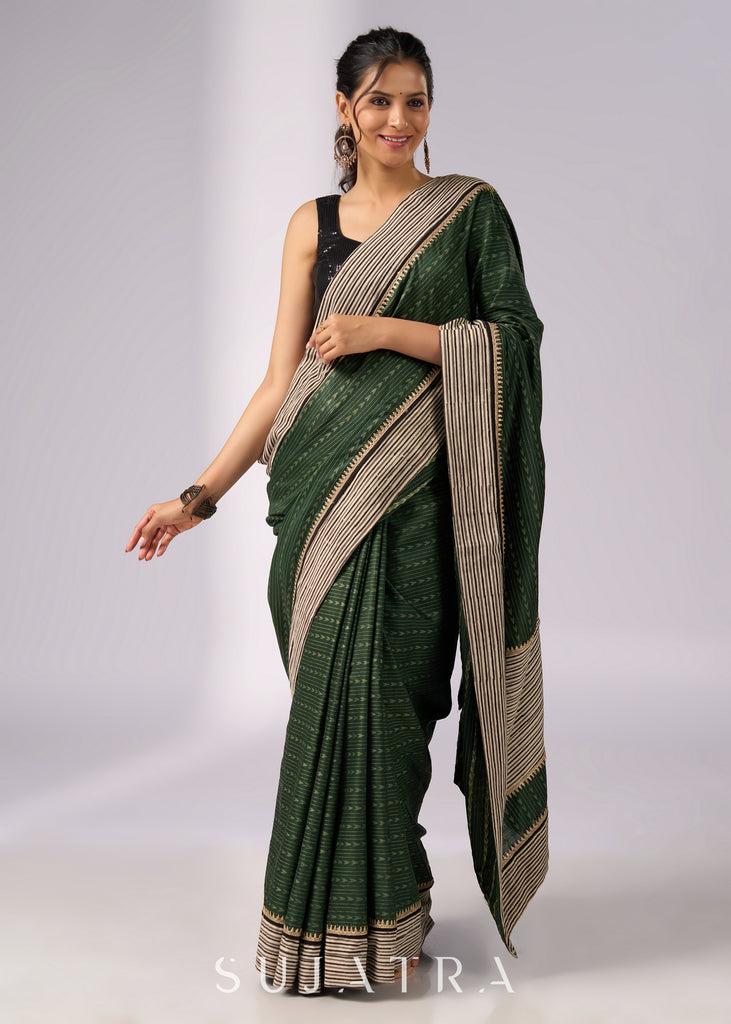 Elegant green cotton saree with intricate striped border & zari highlights