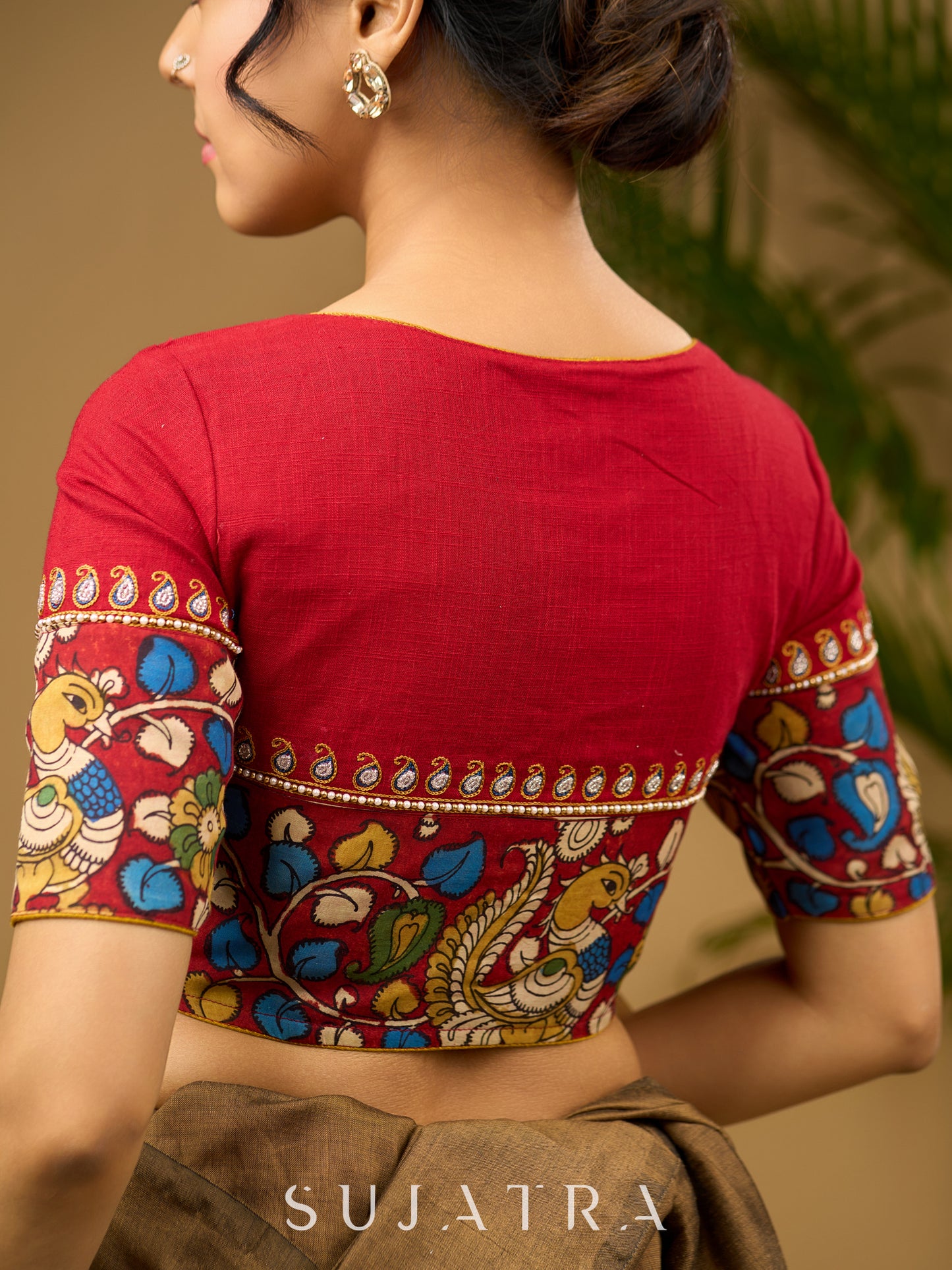 Elegant hand embroidered cotton blouse with intricate kalamkari border design.