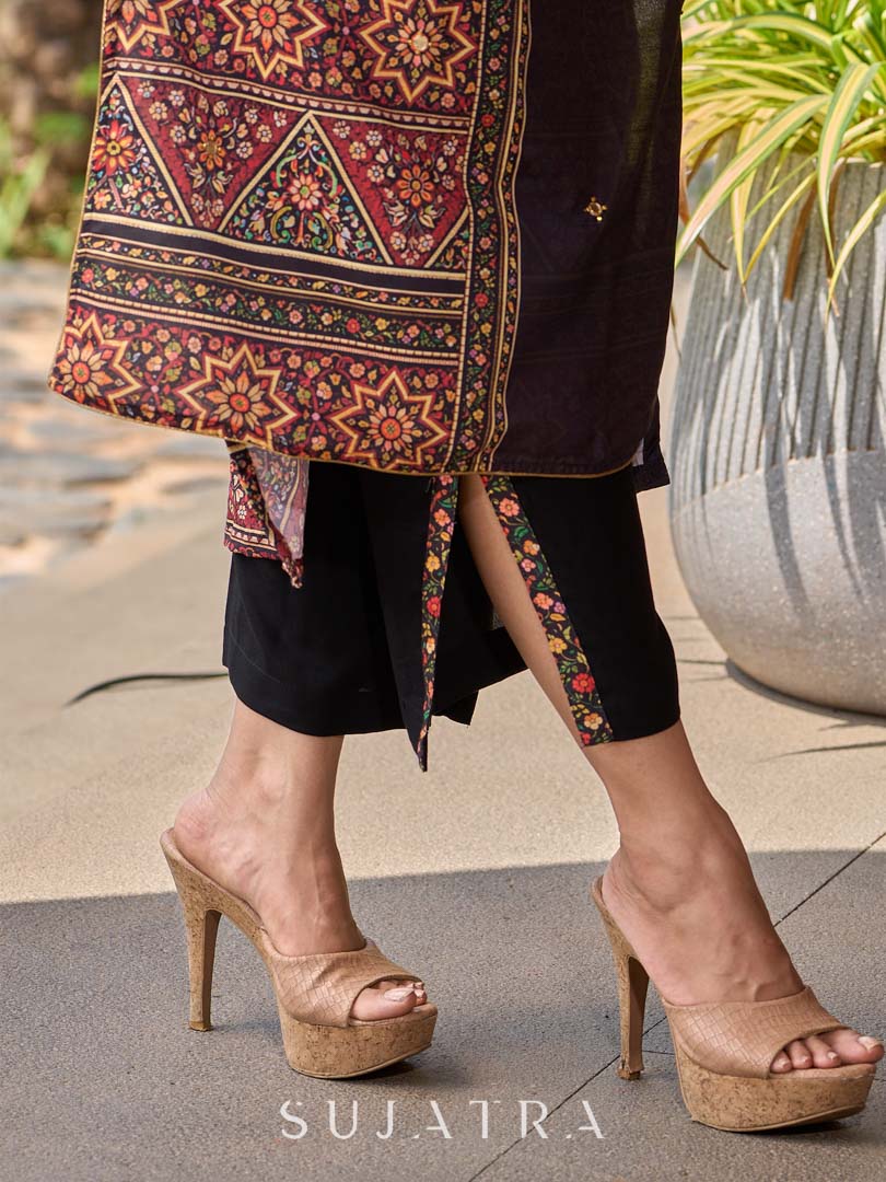 Chic black rayon pants featuring a graceful slit and intricate border detailing.