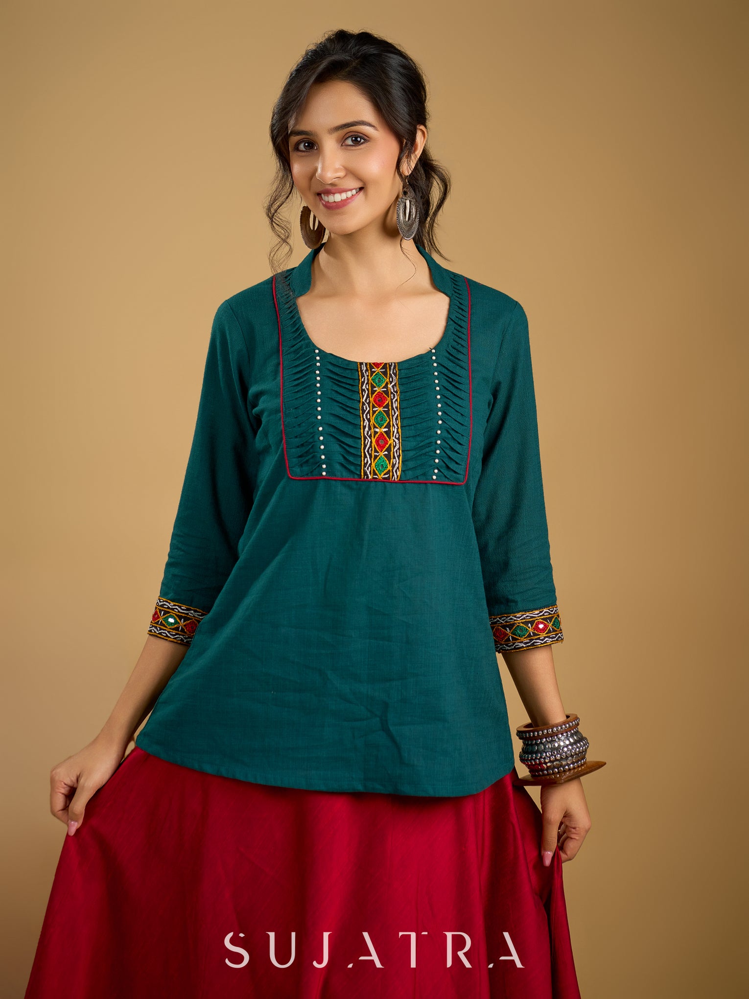 Stylish dark green cotton top with pleats,mirror,and pearl work