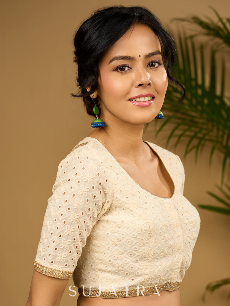 Delicate cotton hakoba blouse with intricate floral patterns.