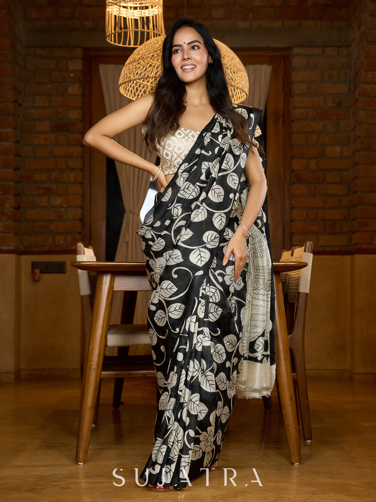 Artisanal black silk saree featuring intricate hand-drawn Kalamkari style motifs