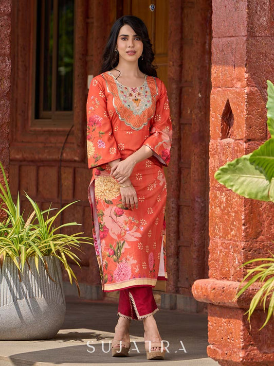 Elegant orange floral printed kurta with hand-embroidered sequin and cut dana detailing on the yoke and rich maroon accents.