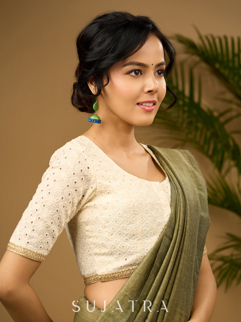 Delicate cotton hakoba blouse with intricate floral patterns.