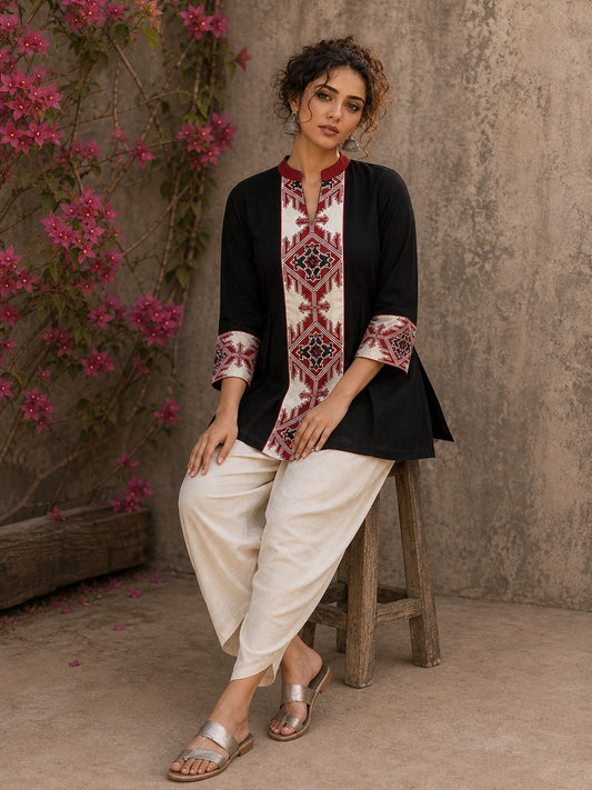Heritage-inspired black top showcasing handcrafted block print panels, elegant maroon trims, and timeless artistry for versatile modern styling.