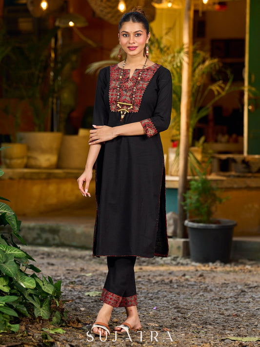 elegant black cotton kurta with beautifully crafted ajrakh panel and subtle stripe piping accents