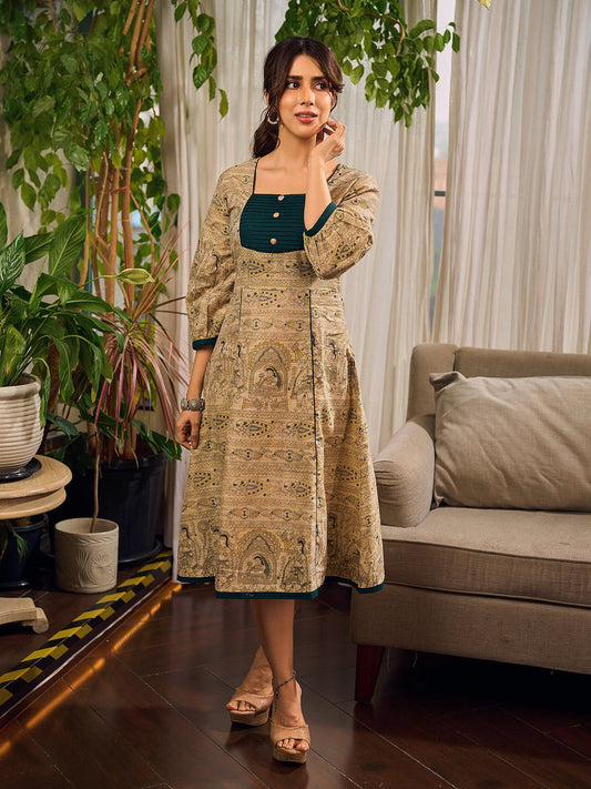 Artisanal beige Madhubani dress featuring intricate motifs, a contrasting green yoke, and refined accents.