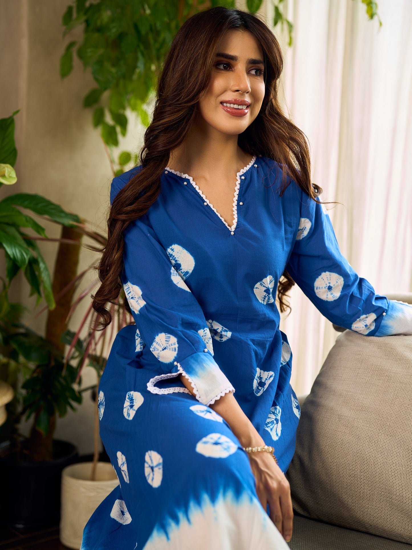 Refreshing cobalt blue shibori tie-dye dress with ivory accents and delicate lace-trimmed neckline.