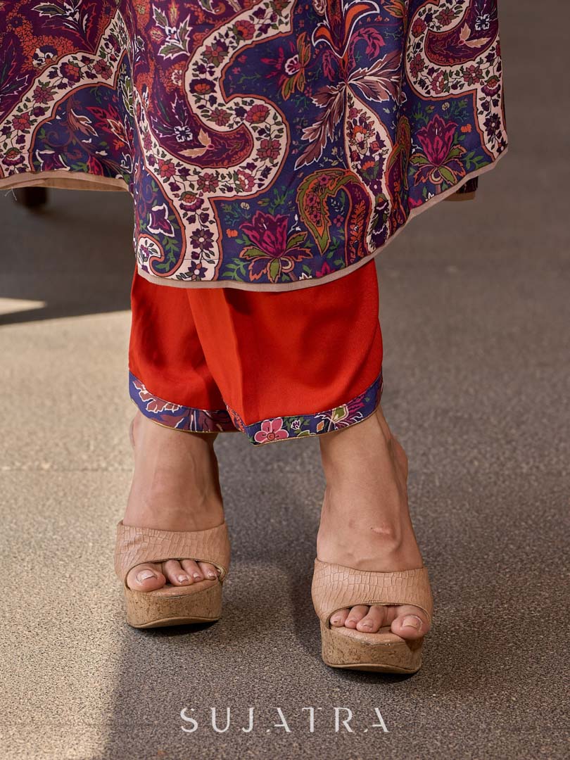 Stylish orange straight pants in soft rayon, accented with a vibrant blue printed border.