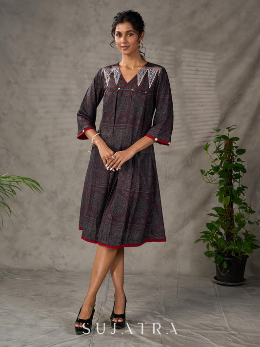 Black Ajrakh printed dress with pleats, maroon accents, and silver embellishments.
