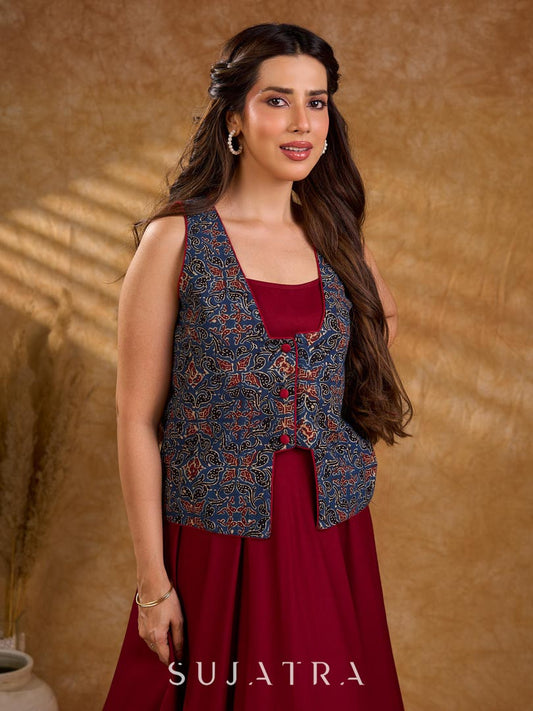Handcrafted Ajrakh sleeveless jacket featuring front flaps, maroon detailing, breathable fabric, and a contemporary ethnic fusion appeal.
