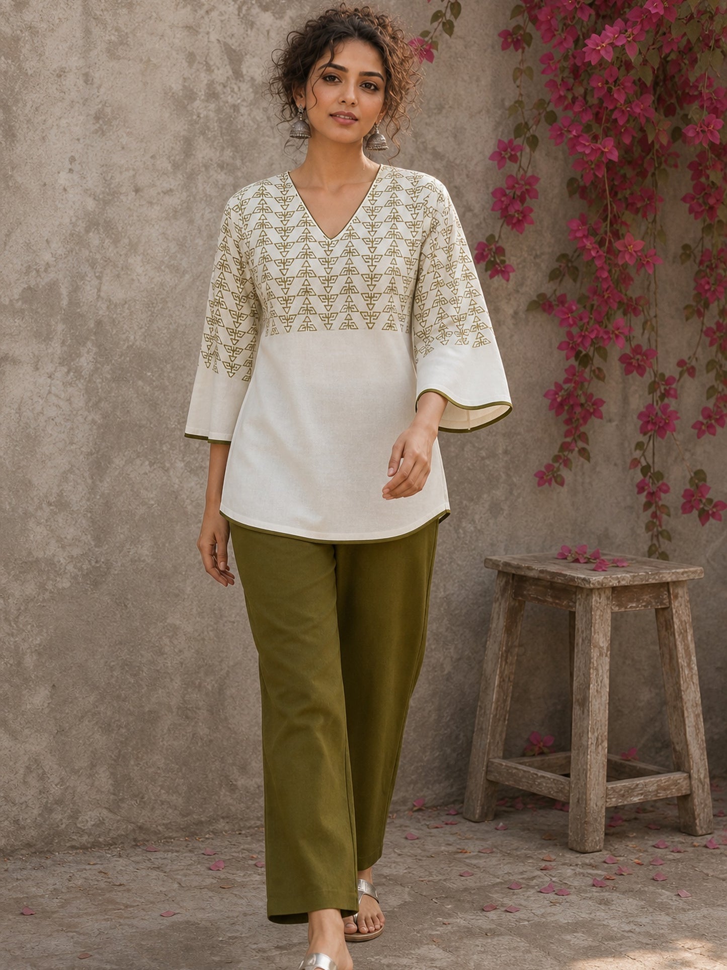 Earthy olive cotton palazzo pants featuring a relaxed silhouette, lightweight fabric, and versatile everyday appeal.