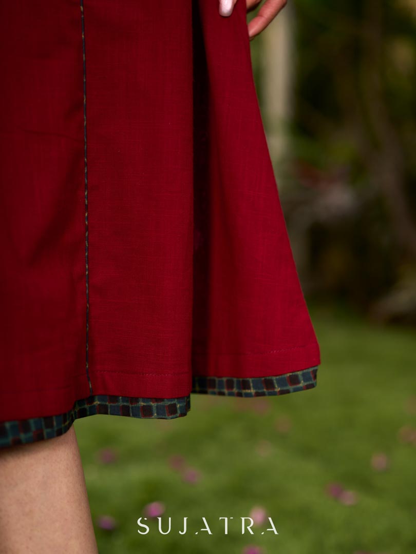 Chic maroon dress featuring a contrasting teal neck patch with charming Peter Pan collar details