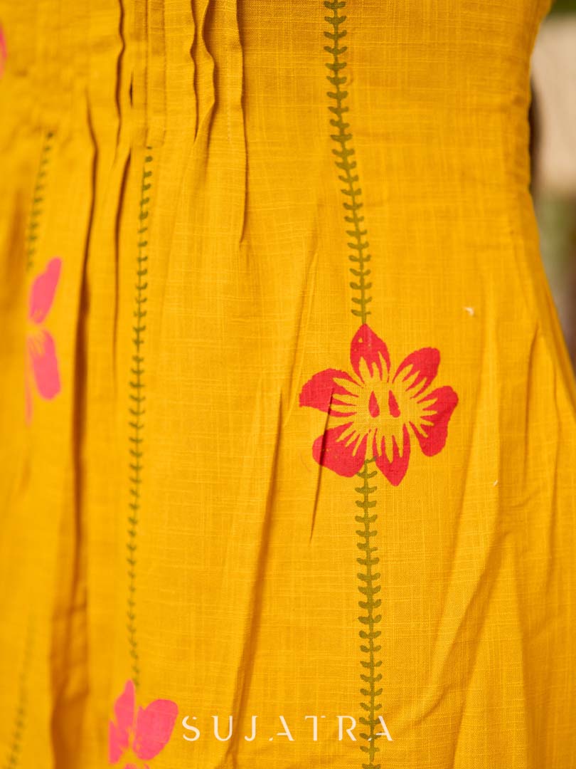 Mustard block printed pintuck dress with hand block red and pink vine floral motifs, accented with red and olive details for a rich, elegant look.