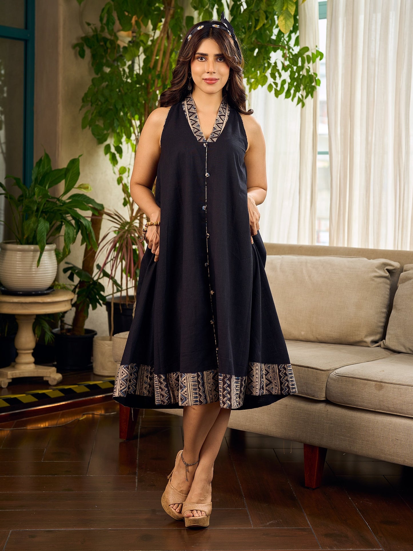 Modern black bias-cut dress showcasing unique artisan-inspired Kalamkari neck trim.