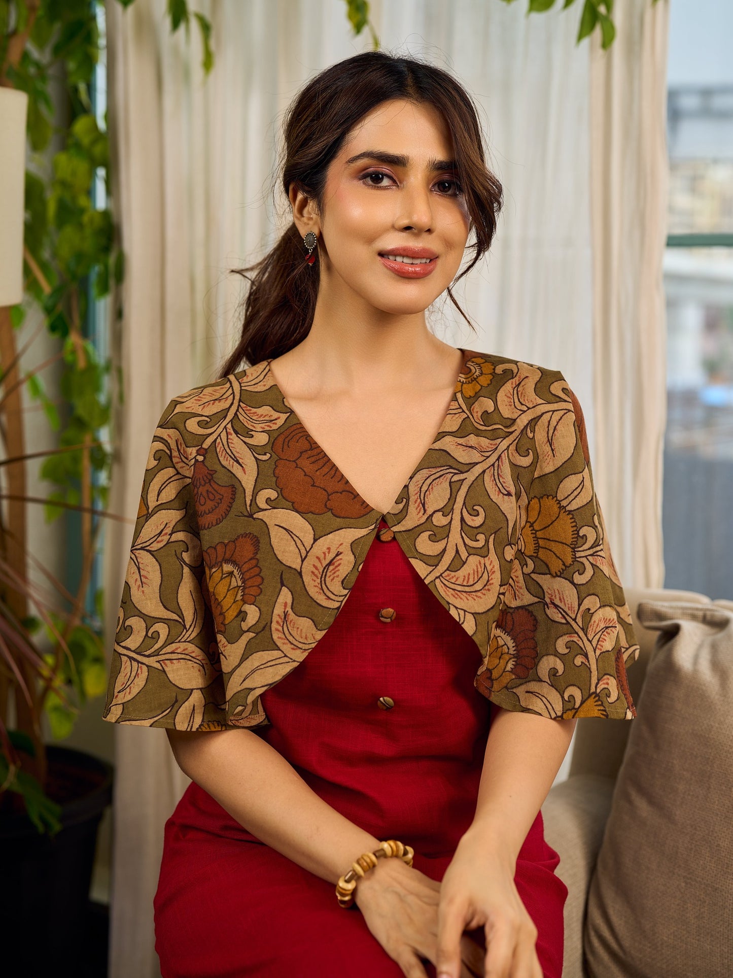 Elegant maroon dress featuring an attached artisan Kalamkari shoulder cape.