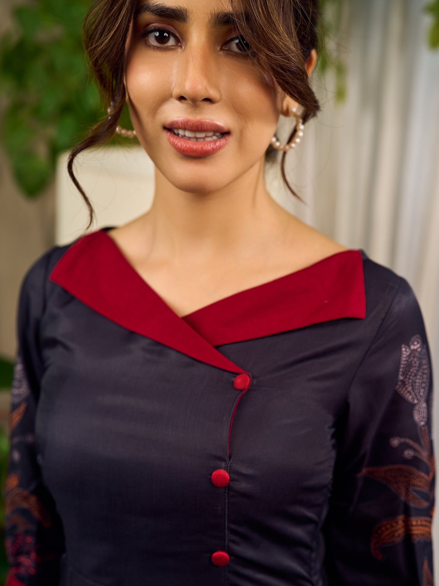 Elegant black Kalamkari-inspired dress with deep maroon accents and graceful floral motifs.