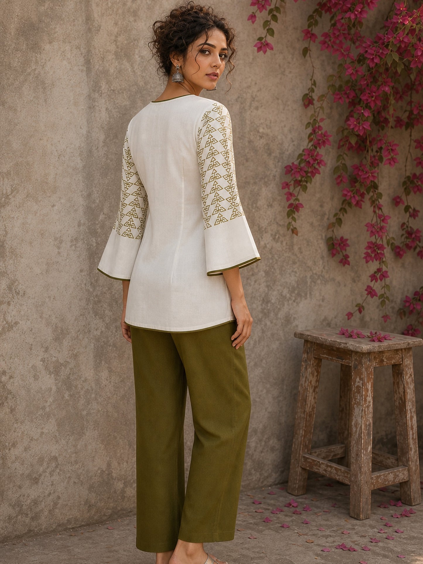 Contemporary off white and olive hand block print top features subtle geometric motifs, airy bell sleeves, and effortless elegance for versatile everyday styling.