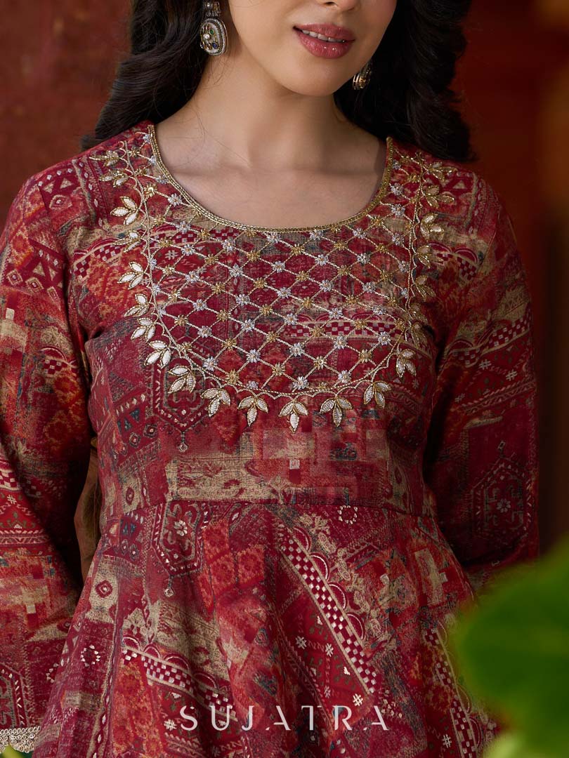 Exquisite deep maroon printed kurta with a graceful bias silhouette, intricate handwork on the yoke, and scalloped sleeve detailing.