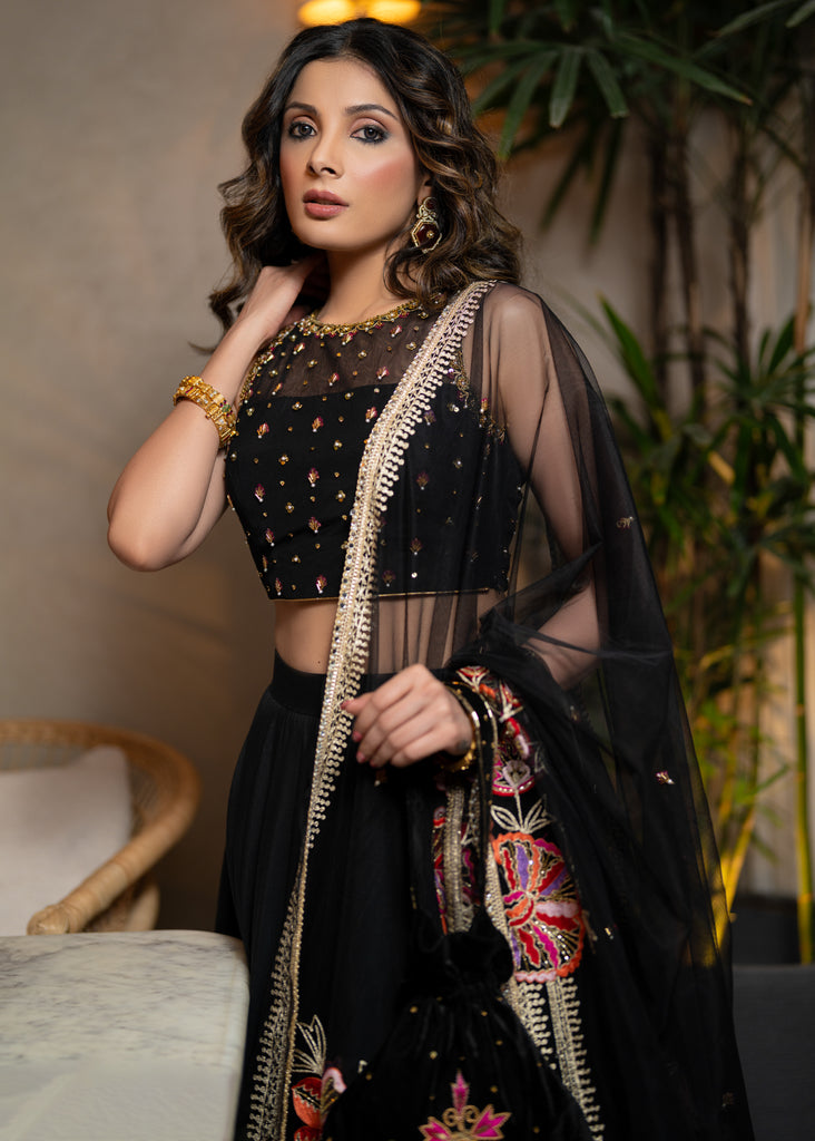 Classic Black Cotton Silk Lehenga paired with delicately embellished net dupatta accentuated with heavy floral embroidery and hand embellishments