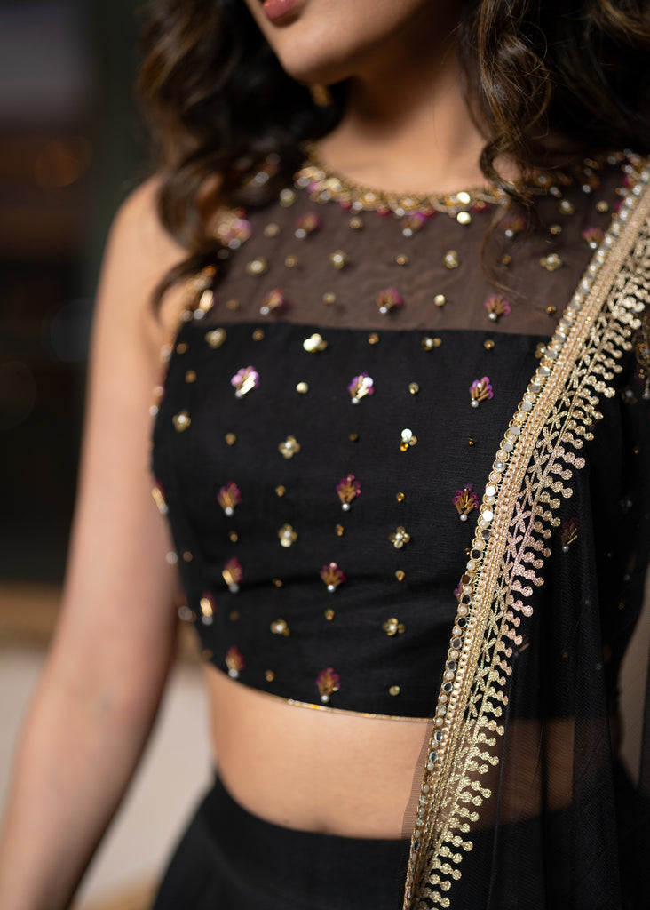 Classic Black Cotton Silk Lehenga paired with delicately embellished net dupatta accentuated with heavy floral embroidery and hand embellishments