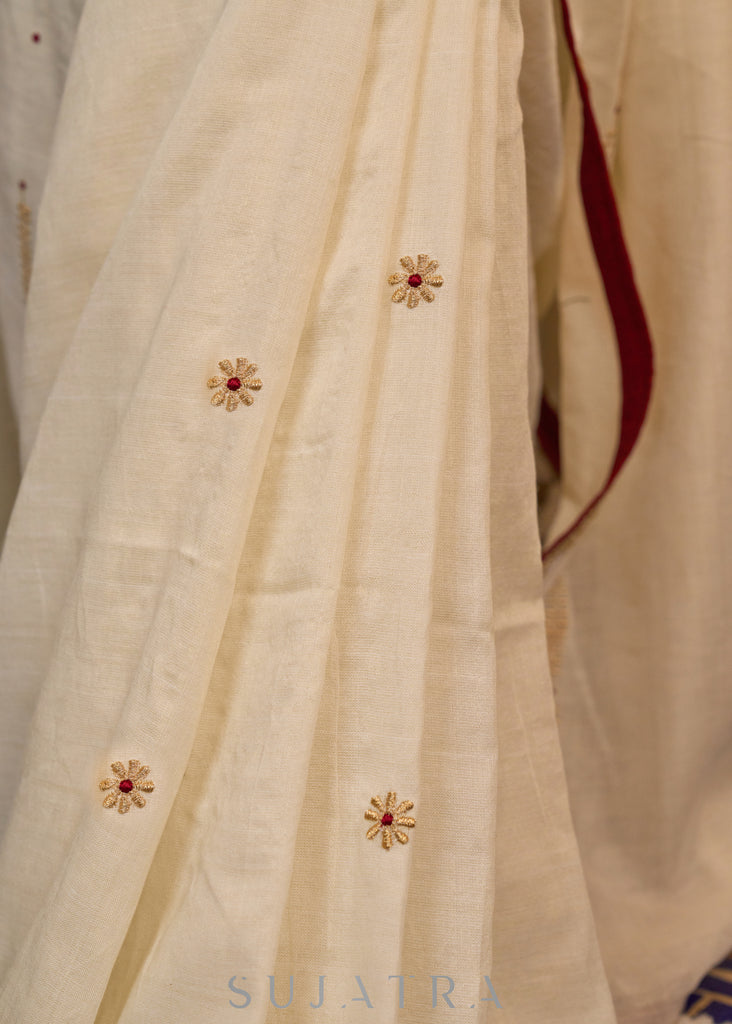 Graceful ivory cotton saree highlighted with beautiful overall intricate embroidery