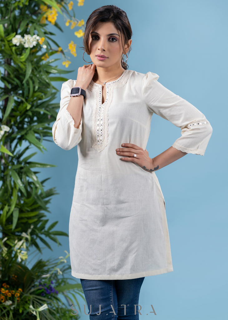 Subtle pearl white cotton tunic highlighted with matching mirror lace