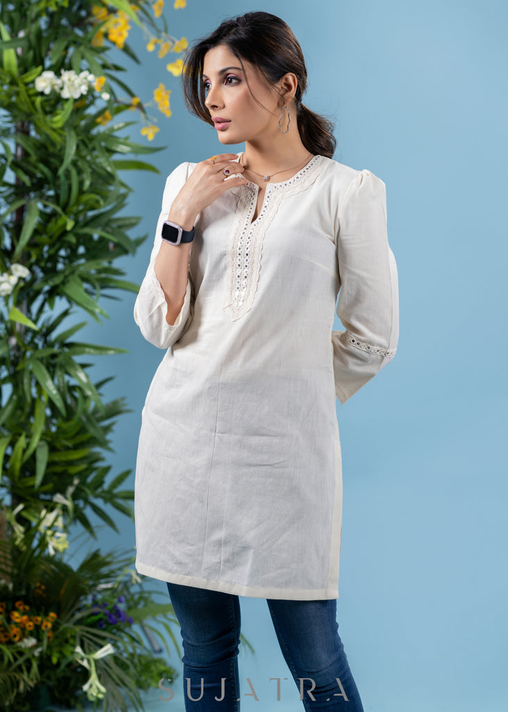 Subtle pearl white cotton tunic highlighted with matching mirror lace