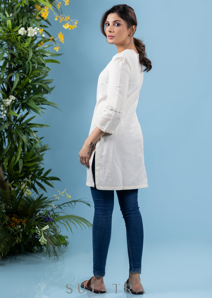 Subtle pearl white cotton tunic highlighted with matching mirror lace