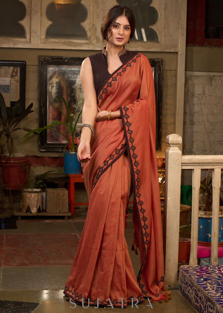 Graceful rust cotton plain saree highlighted with overall ajrakh applique border