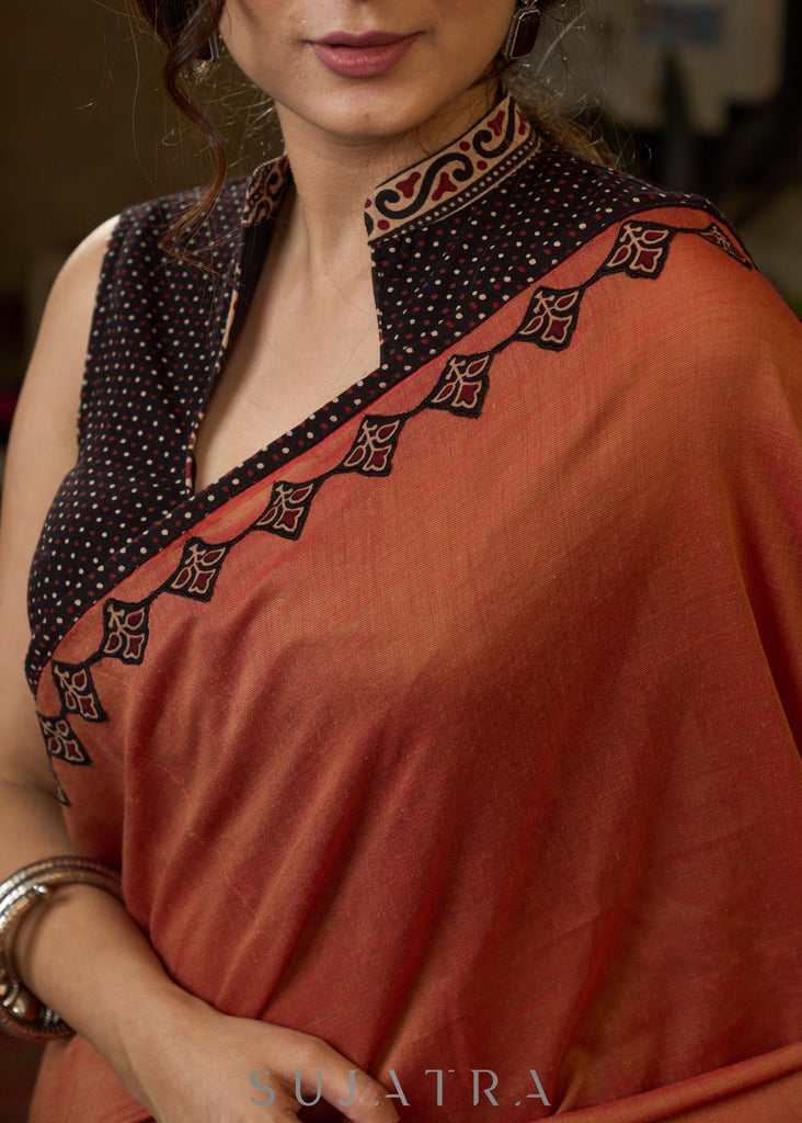 Graceful rust cotton plain saree highlighted with overall ajrakh applique border