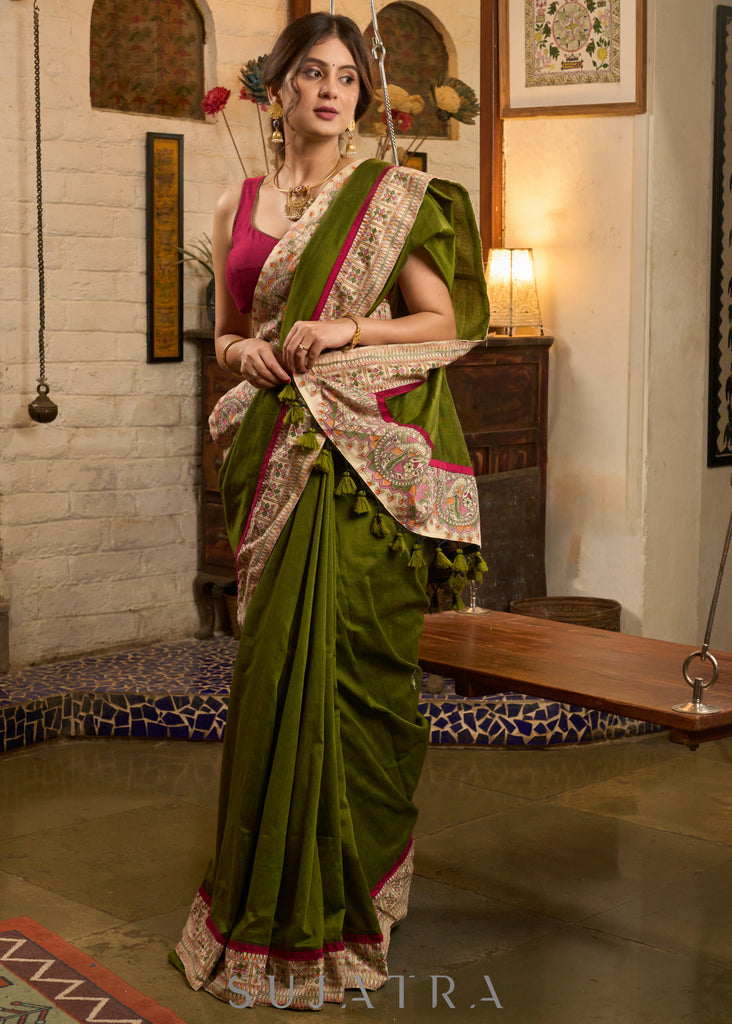 Elegant moss green cotton saree highlighted with handpainted madhubani