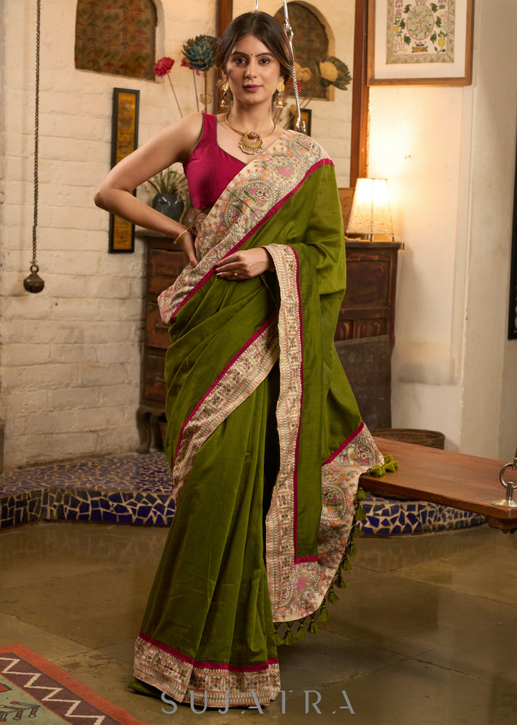 Elegant moss green cotton saree highlighted with handpainted madhubani