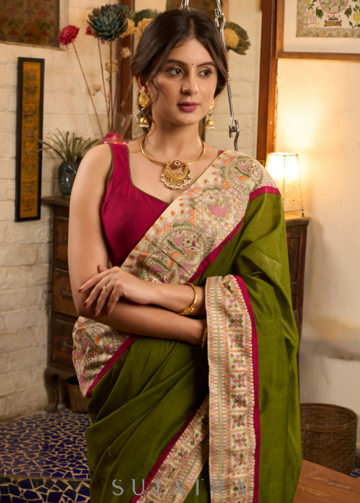 Elegant moss green cotton saree highlighted with handpainted madhubani