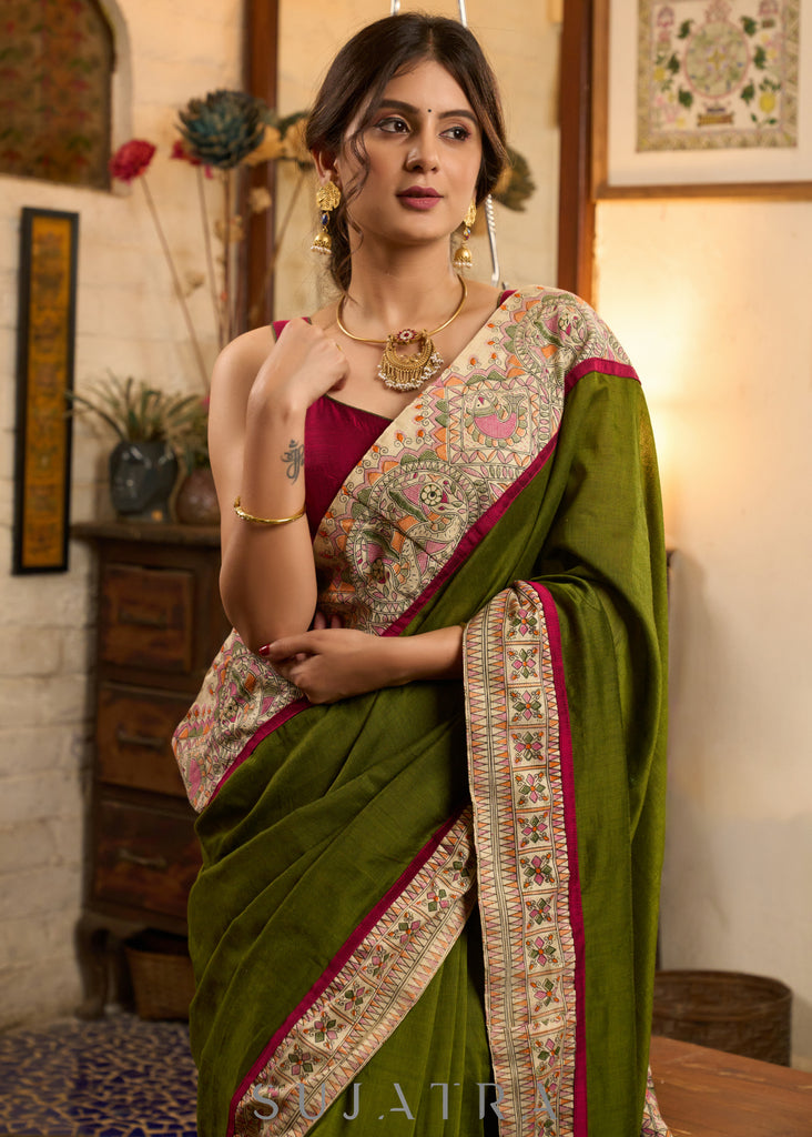 Elegant moss green cotton saree highlighted with handpainted madhubani