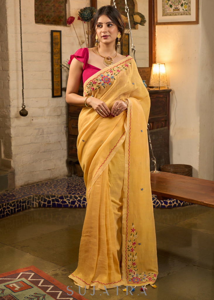 Beautiful yellow cotton saree highlighted with multicolor floral embroidery